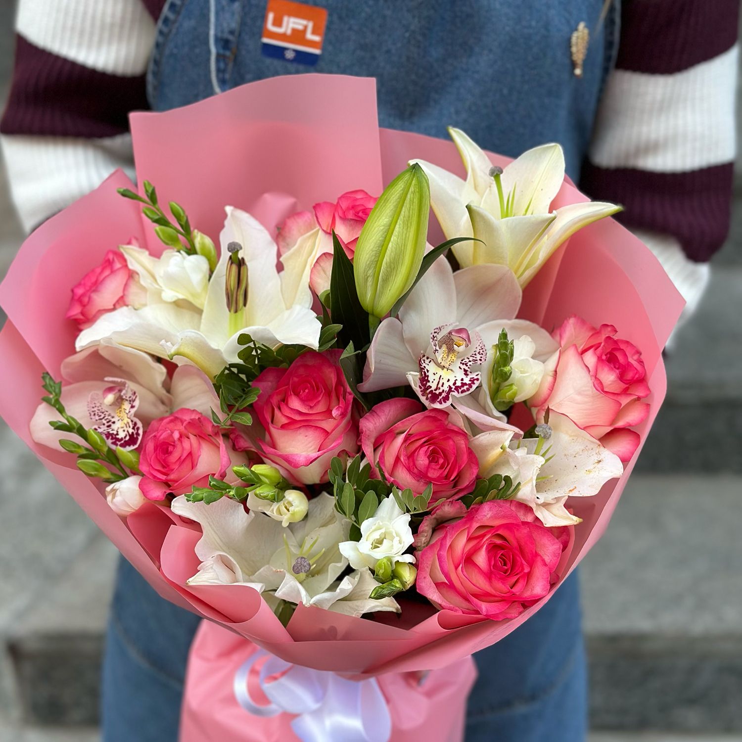 pink rose (7 pcs.), white lily, white freesia, white cymbidium, packaging, ribbon