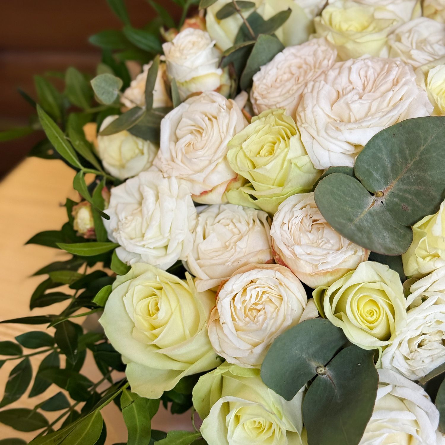 white rose (21 pcs.), cream spray rose (10 pcs.), eucalyptus, decorative elements, oasis, round box, packaging, ribbon